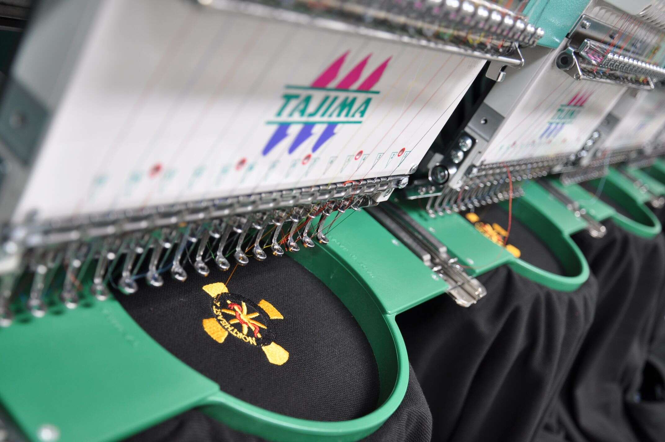 Tajima heads stitching a logo in our shop