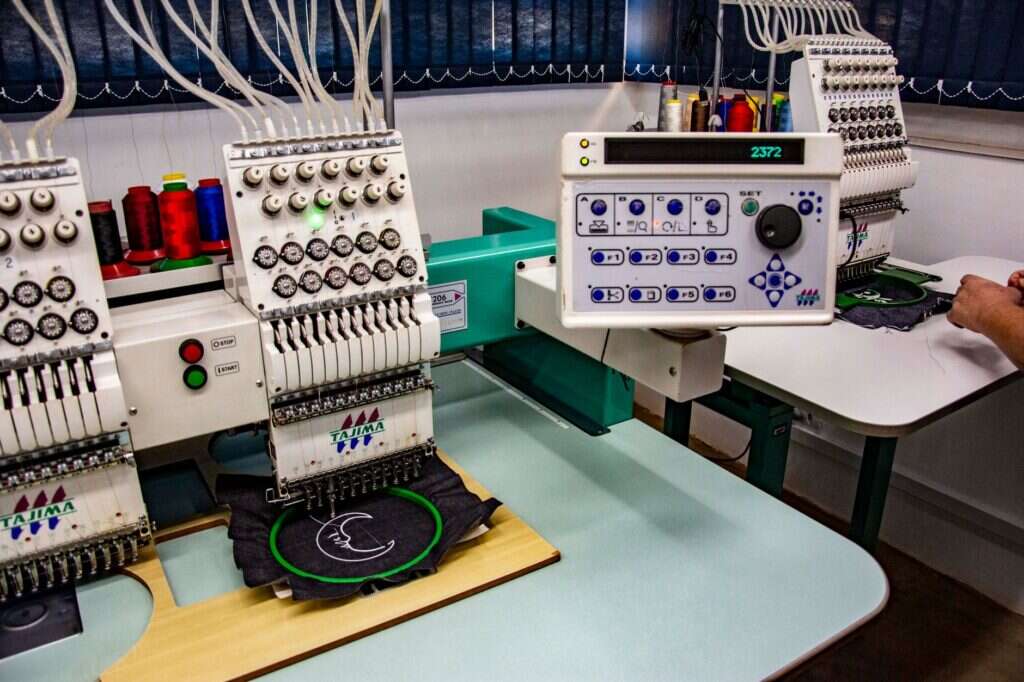 Rows of commercial embroidery machines